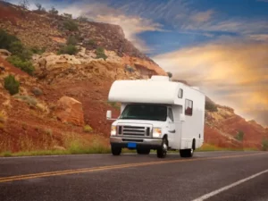 An RV driving down a scenic road.