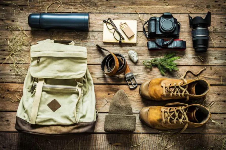 Overhead shot of outdoor gear laid on a wooden table.