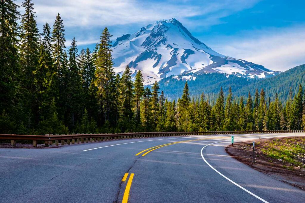 Forested highway in Oregon with Mount Hood in the background.