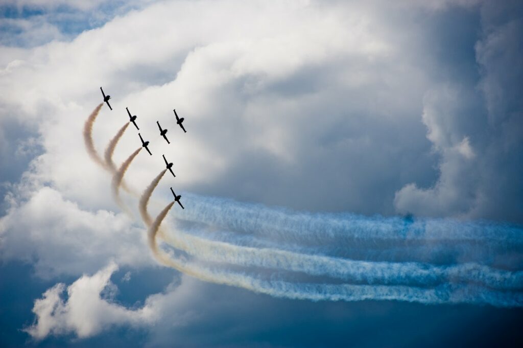 A group of airplanes flying during an air show.