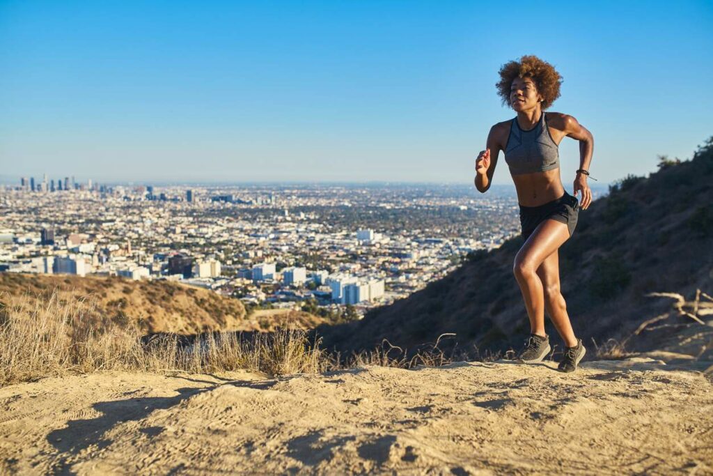 A woman running the side of a mountain near Los Angeles in southern California.