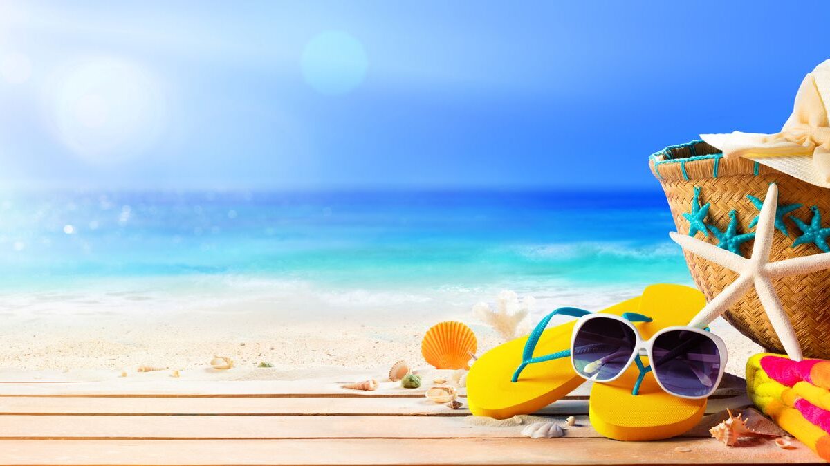 An assortment of beach accessories set on a table at the beach.