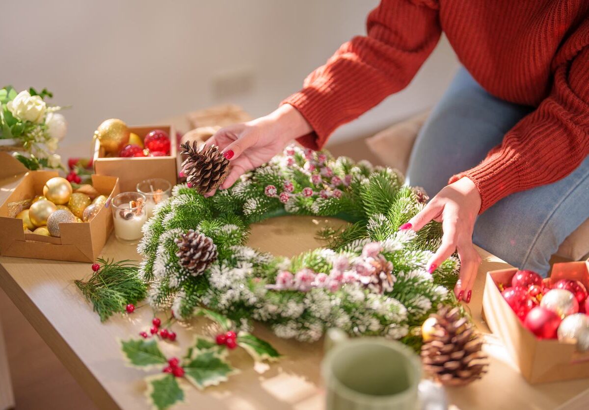 A woman creates a wreath in preparation for the upcoming holiday season.