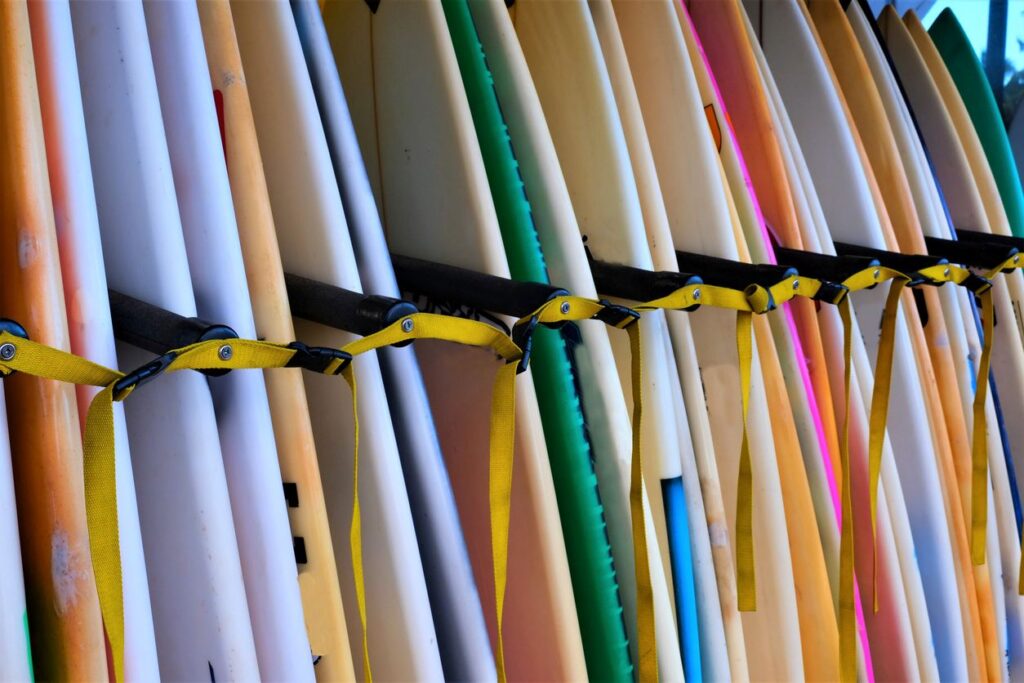 Colorful surfboards lined up in a rack.